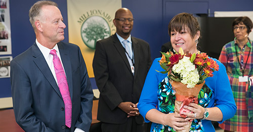 Dr. Martirano with Maddy Halbach accepting bouquet of flowers