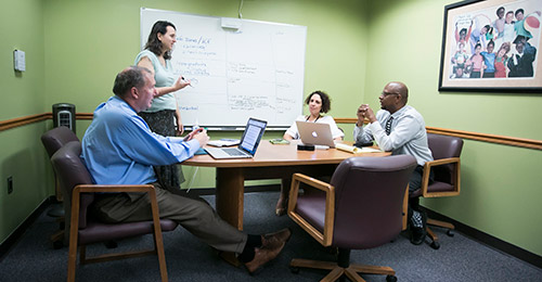 Kevin Gilbert in a meeting with colleagues.