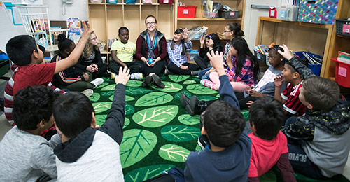 Elizabeth Diaz teaching sitting with students in a circle.