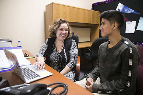 ESOL Support Counselor Lori Miller meeting with a student.